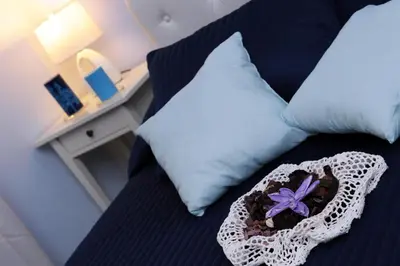 a bedroom with a bed with a pillow and a box with a flower at B&B Alexander in Rome