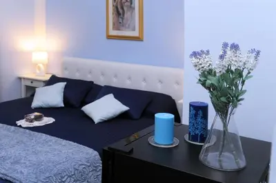 a bedroom with a bed with a vase of flowers on a table at B&B Alexander in Rome