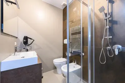 a bathroom with a shower and a toilet and a sink at Castro Pretorio in Rome