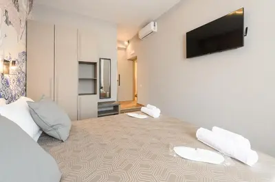 a room with a bed with a flat screen tv on the wall at Castro Pretorio in Rome