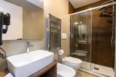 a bathroom with a sink and a toilet and a shower at Castro Pretorio in Rome