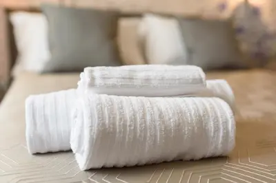 two white towels sitting on top of a table at Castro Pretorio in Rome
