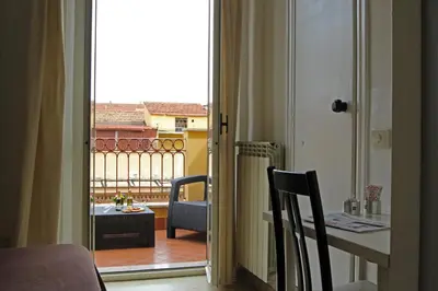 an open door to a balcony with a table and chairs at Hotel Indipendenza in Rome