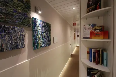 a hallway with two paintings on the wall at Hotel Indipendenza in Rome
