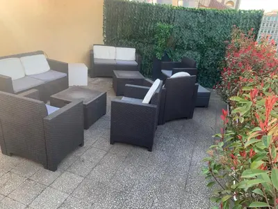 a group of chairs and tables on a patio at Hotel Indipendenza in Rome