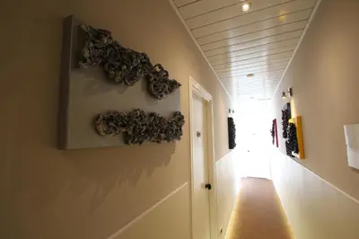 a hallway with a bunch of rocks on the wall at Hotel Indipendenza in Rome