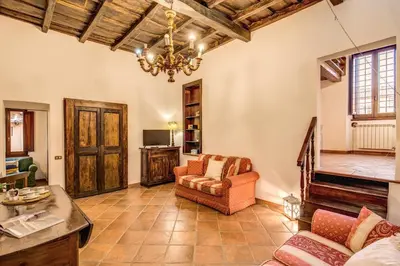 a living room with a couch and a chandelier at FRESH HOUSE TREVI 2 in Rome
