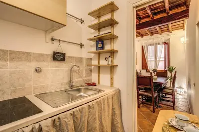 a kitchen with a sink and a table at FRESH HOUSE TREVI 2 in Rome