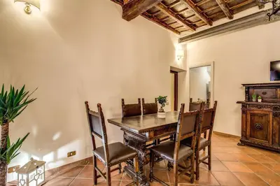 a dining room with a wooden table and chairs at FRESH HOUSE TREVI 2 in Rome