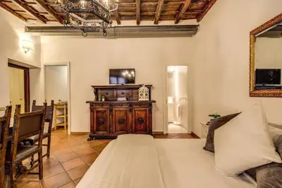 a room with a bed and a dresser in it at FRESH HOUSE TREVI 2 in Rome