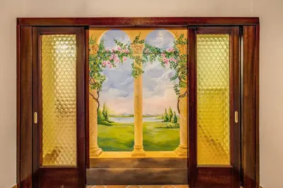 a door with a painting of a cross on it at FRESH HOUSE TREVI 2 in Rome