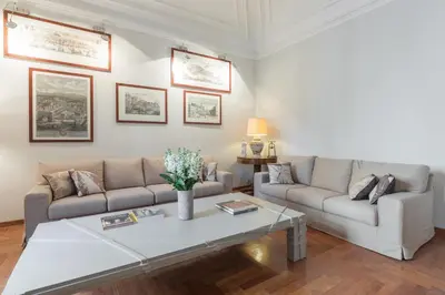 a living room with two couches and a coffee table at Amazing 4 bedrooms apartment with garden in Rome