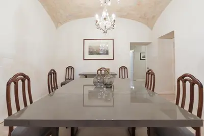 a dining room with a large table and chairs at Amazing 4 bedrooms apartment with garden in Rome