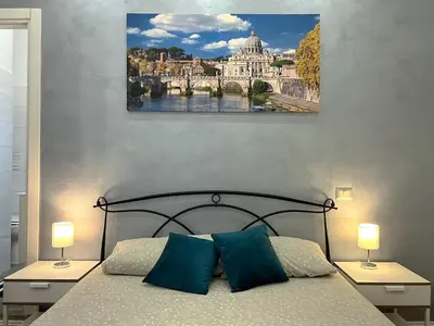 a bedroom with a bed with two lamps on tables at La Terrazza a San Pietro in Rome