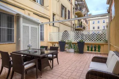 a patio with a table and chairs on a balcony at La Terrazza a San Pietro in Rome