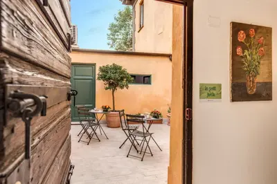 an open door to a patio with tables and chairs at Gonfalone 6 in Rome