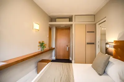 a hotel room with a bed and a hallway at Gonfalone 6 in Rome