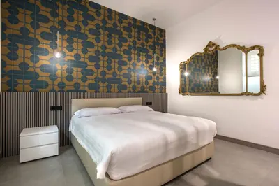 a bedroom with a large bed and a mirror at Gonfalone 6 in Rome