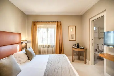 a bedroom with a bed and a flat screen tv at Gonfalone 6 in Rome
