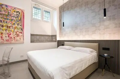 a bedroom with a bed and a painting on the wall at Gonfalone 6 in Rome