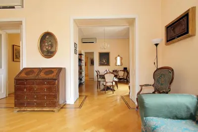 a living room with a couch and a table and chairs at Vatican House Via Terenzio in Rome