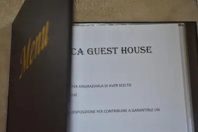a book with the title of a guest house at romantica guest house in Rome