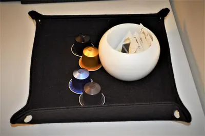 a black plate with candles and a white bowl at romantica guest house in Rome