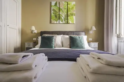 a bedroom with a large bed with two pillows at SuityRHome RioneMonti37 in Rome