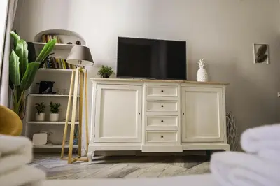 a white dresser with a television on top of it at SuityRHome RioneMonti37 in Rome