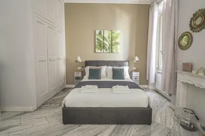 a bedroom with a large bed and a fireplace at SuityRHome RioneMonti37 in Rome