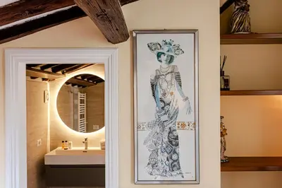 a drawing of a woman on a wall next to a sink at Luxury Apartment Pantheon in Rome