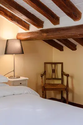 a bedroom with a bed and a chair and a lamp at Luxury Apartment Pantheon in Rome