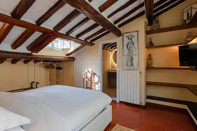 a bedroom with a white bed and a tv at Luxury Apartment Pantheon in Rome
