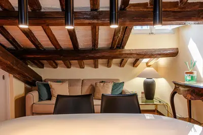 a living room with a couch and a table and chairs at Luxury Apartment Pantheon in Rome