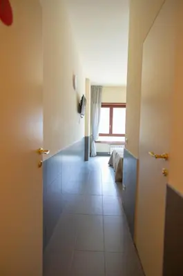 a hallway with a room with a bed and a window at tiaspettoaroma in Rome