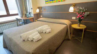 a hotel room with two beds with towels on them at tiaspettoaroma in Rome