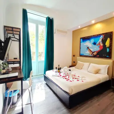 a bedroom with a bed with flowers on it at Chroma Italy - Chroma Deka in Rome
