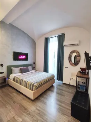 a bedroom with a king sized bed and a window at Chroma Italy - Chroma Deka in Rome