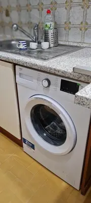 a washing machine in a kitchen with a sink at Vatican Meloria House in Rome
