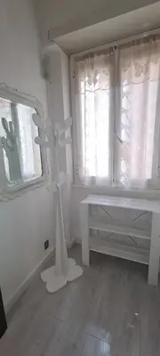a white room with a white table and windows at Vatican Meloria House in Rome