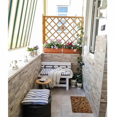 a small balcony with two benches and a table at Vatican Meloria House in Rome