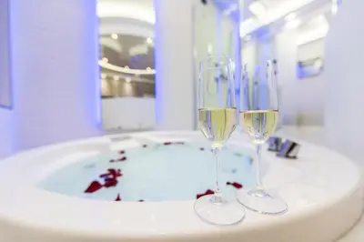 two wine glasses sitting on top of a bathroom sink at LUX Suites in Roma in Rome