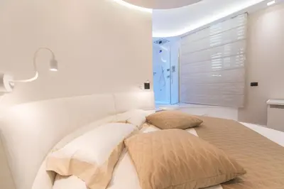 a bedroom with a bed with two pillows at LUX Suites in Roma in Rome