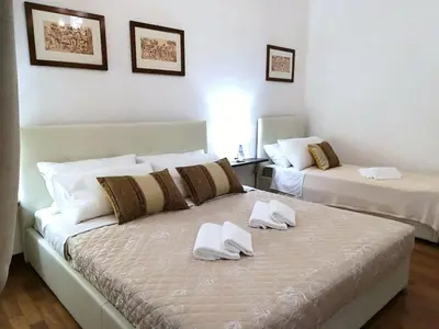 a bedroom with two beds with white towels on them at Vatican Area House in Rome