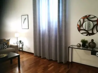 a room with an old wooden dresser and a chair at Vatican Area House in Rome