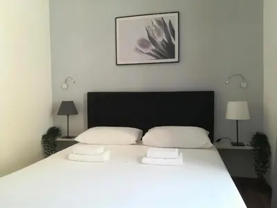a bedroom with a large bed with two pillows at Vatican Area House in Rome