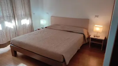 a bedroom with a bed and two lamps on tables at B&B Alle mura di San Giovanni in Rome