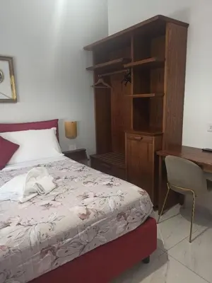 a bedroom with a bed and a desk and a desk at B&B Alle mura di San Giovanni in Rome