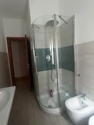 a bathroom with a shower and a toilet and a sink at B&B Alle mura di San Giovanni in Rome