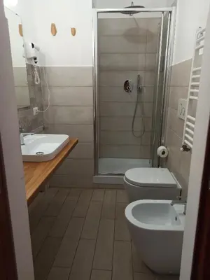 a bathroom with a shower and a toilet and a sink at B&B Alle mura di San Giovanni in Rome